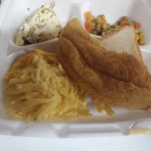 Fried catfish,  baked spaghetti, potato, salad, and peas and carrots.