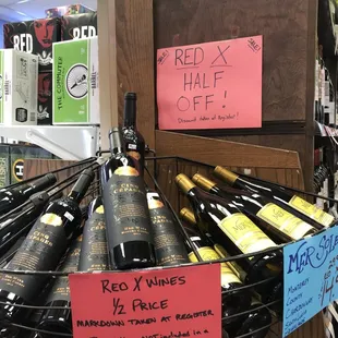 Red X - Half off wines located towards the back of the store on aisle endcaps