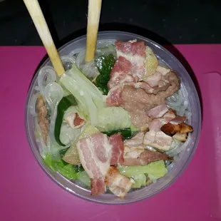 Container view of the clear Chinese noodles with pork. Available with one days notice!