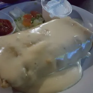 The beef and bean chimichanga, smothered in a blanket of rich, creamy queso.