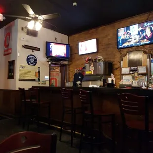 a bar with two televisions