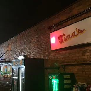 a neon sign above a bar