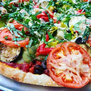 Close up of vegan pizza with tons of veggies.