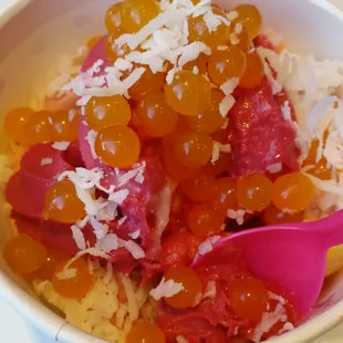 Coconut, mango passion, and pomegranate raspberry topped with mango balls and coconut shreds. Yummy!