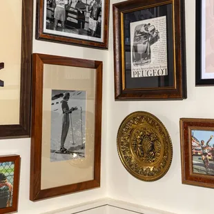 a wall of framed photographs and framed photographs