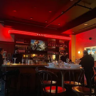 people at a bar with red lights