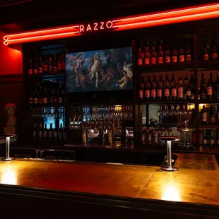 a dimly lit bar with a lot of bottles