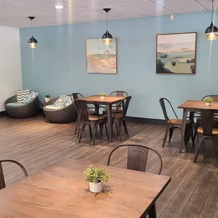 a dining area with tables and chairs