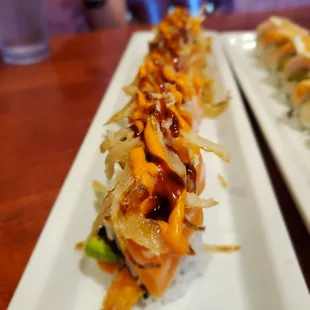 two plates of sushi on a table