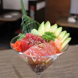 a glass of sushi on a table