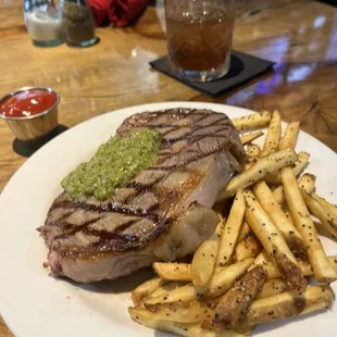 Ribeye steak with chimichurri, french fries and a smoky mule.
