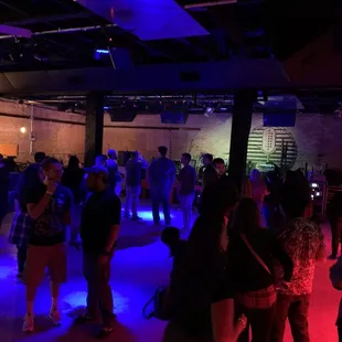 a group of people dancing in a dark room