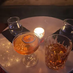 two glasses of alcohol on a table