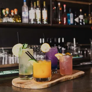 a variety of cocktails on a bar counter
