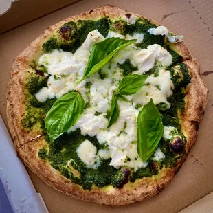 Margherita pizza with fresh made pesto and ricotta.