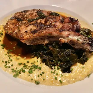 Pork Chop (cooked to perfection) w. spicy collard greens, and gruyere &amp; Beecher&apos;s cheddar grits. One of my fav meals of all time, delicious