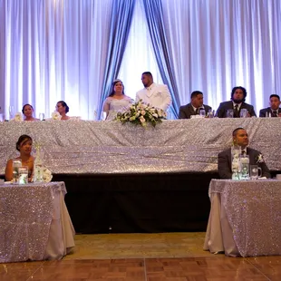 Sequin table covers, pipe and draping, and uplighting provided by REA Designs