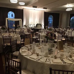Our beautiful ballroom! Chiavari chairs, table cloths, napkins, sweetheart table linen, suspended wedding cake and back drop all from REA
