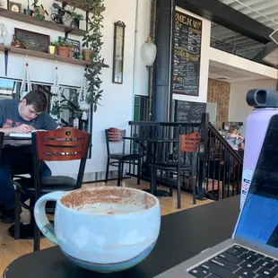 a laptop and a cup of coffee on a table