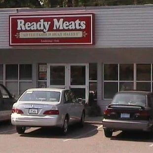 cars parked in front of a restaurant