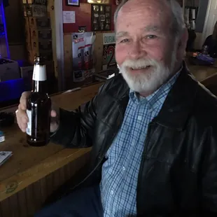 a man holding a bottle of beer