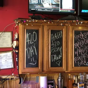 a bar with chalkboard menus