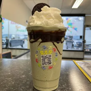 a milkshake with a cookie on top