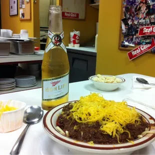 This is a picture of a beer and a bowl of chili