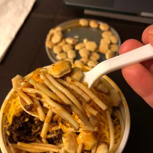 Spaghetti and chili with hot sauce and cheese