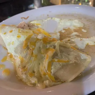 Chicken enchilada swimming in liquid