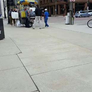 a man in a blue shirt and a dog on a leash