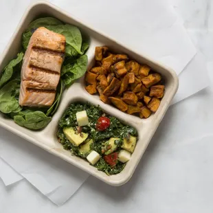 Seared to order salmon, roasted sweet potatoes, and kale/avocado salad!