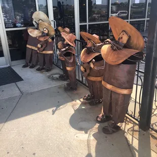 a line of statues of mexican musicians