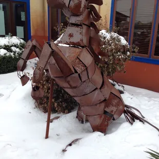 a horse sculpture in the snow