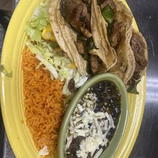 Tacos coyotes this dish one of my favorites making with sirloin steak poblano peppers black beans rice lettuce and mango sauce