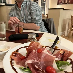 a man sitting at a table with a plate of food