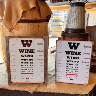 two wine tasting signs on a table