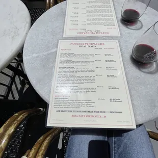 a person sitting at a table with a menu