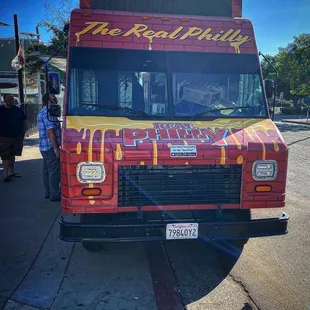 a red and yellow food truck