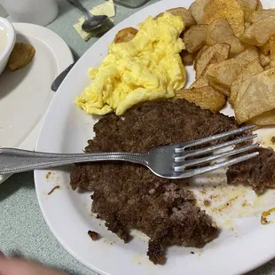 Hamburger steak and eggs and sliced potatoes