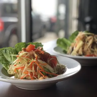 Classic Papaya Salad (Som Tum) ()
 Fresh young papaya, carrot, tomatoes, peanut, green bean with homemade sauce.