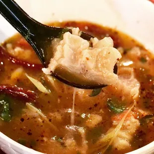 a bowl of soup with a spoon in it