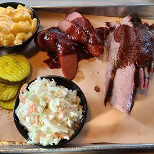 2 meat dinner with sausage, brisket, Mac, and slaw. Spicy sauce on top because I love it!