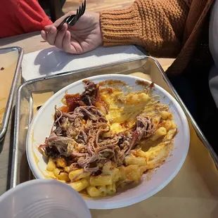 Mac and cheese covered in pulled pork