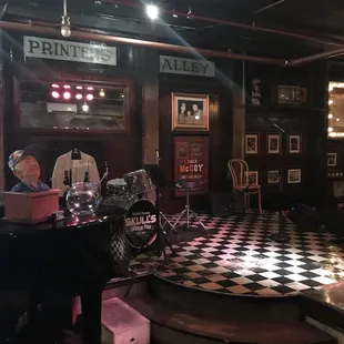 a man playing the piano in a pub