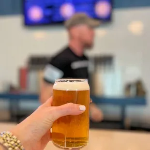 a person holding a glass of beer