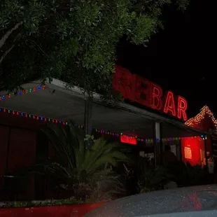 a car parked in front of a bar