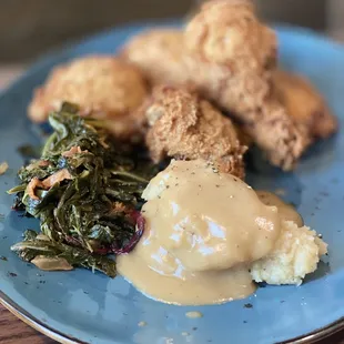 Fried Chicken with Greens and Brown Butter Mashed Potatoes.  These potatoes had chicken gravy on them.