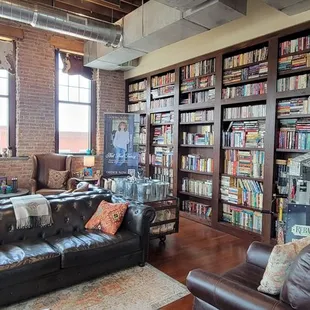 two people in a room with a bookcase