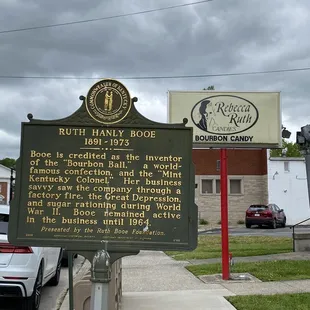 a historical sign on the corner of a street